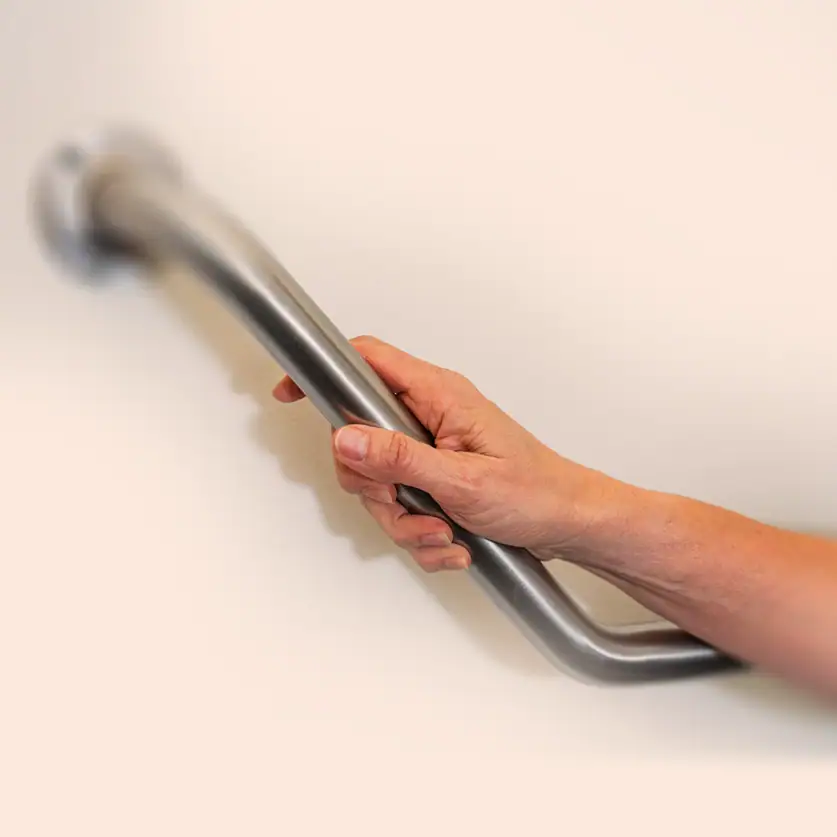 Handrail being installed on a wall for improved accessibility.