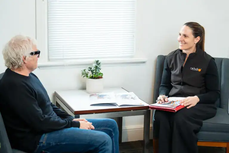 RehabCo consultant in a seated consultation with a client