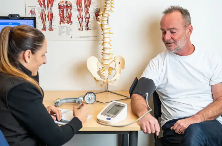 A RehabCo clinician running an on-site health check for a worker