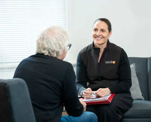RehabCo employment specialist providing person-centred support in a seated consultation